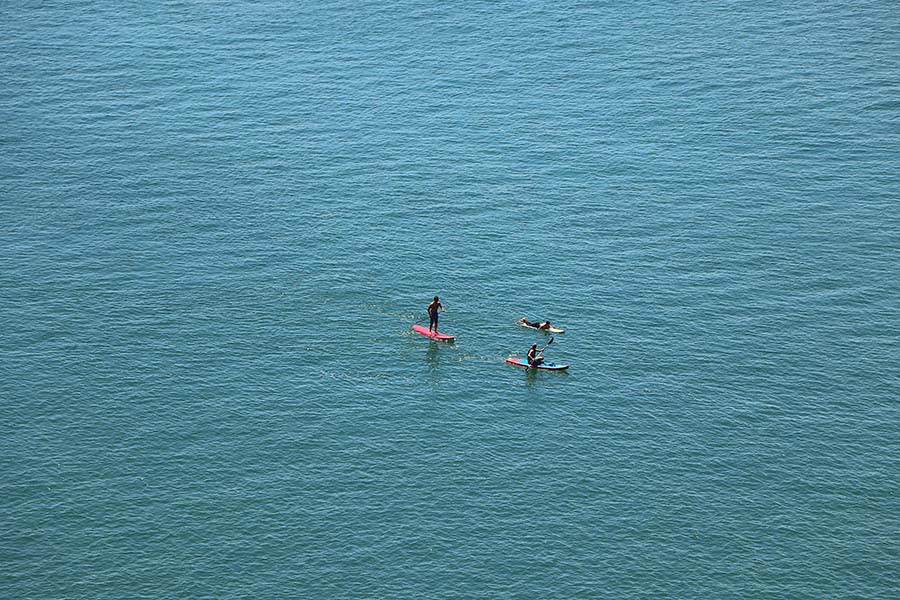 Family paddleboarding on calm waters at Croyde Bay, North Devon